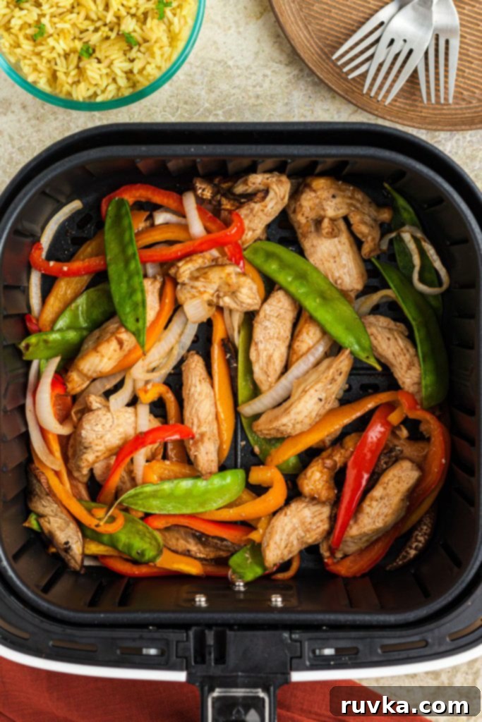 Crispy Air Fryer Stir-Fry 7 Juicy cooked chicken with stir fry vegetables in the air fryer basket after being cooked
