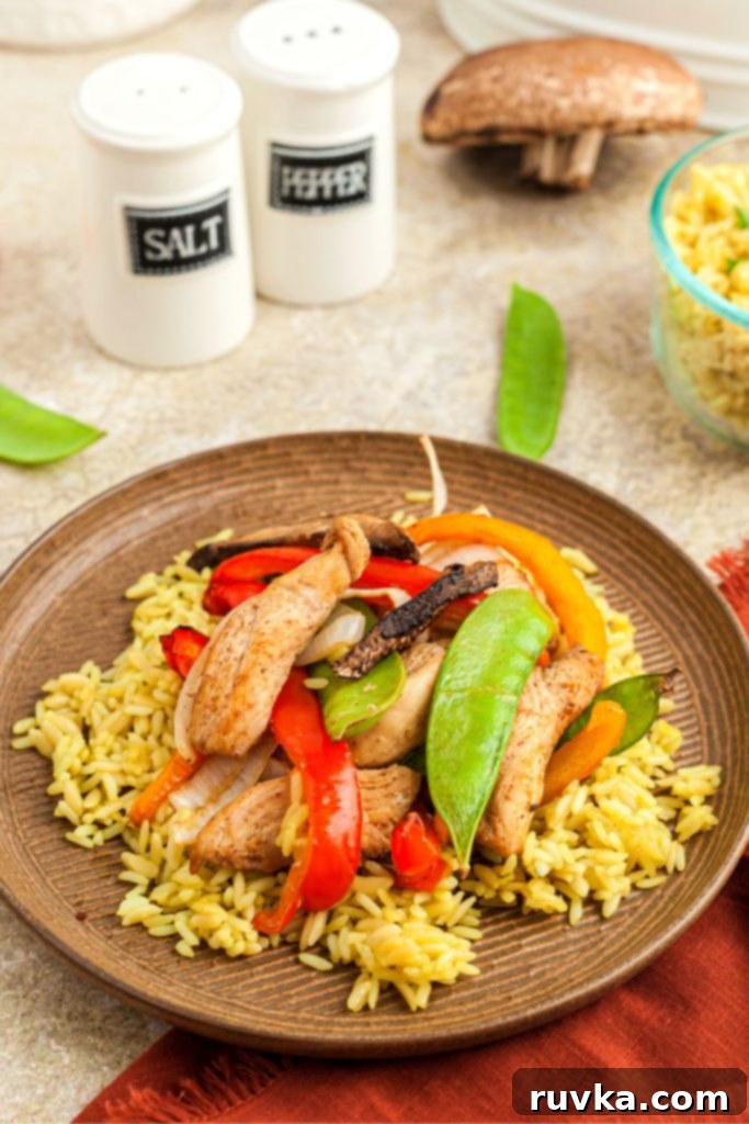 Crispy Air Fryer Stir-Fry 8 Chicken stir fry served over rice on a light brown plate