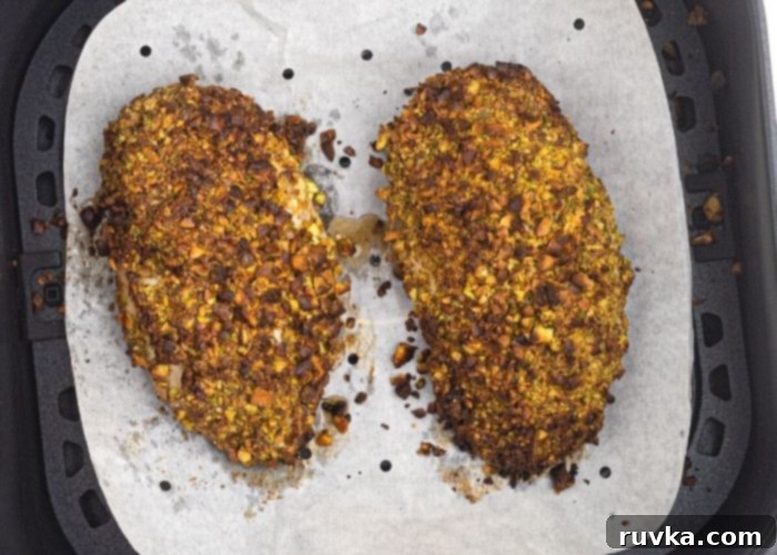 Crispy Pistachio Air Fryer Chicken 7 Pistachio Crusted chicken in the air fryer basket, after cooked.