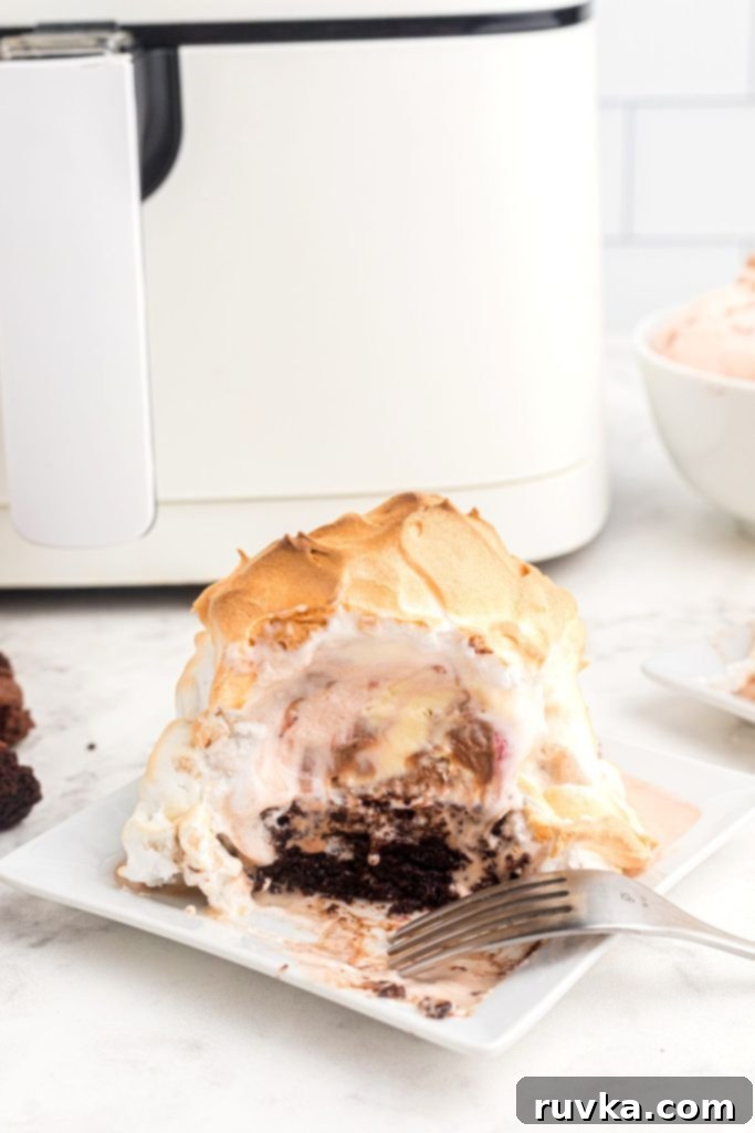 Decadent Air Fryer Brownie Baked Alaska 2 Brownie topped with ice cream and meringue air fried and served on a white square plate