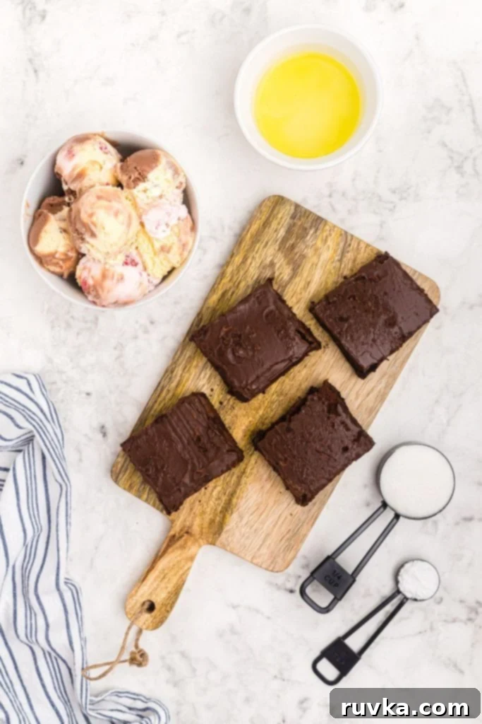 Decadent Air Fryer Brownie Baked Alaska 3 Ingredients to make brownie baked Alaska measured out onto a white marble board