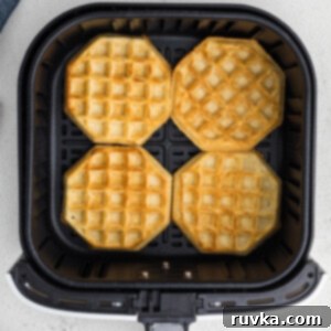 Frozen Waffles: Air Fryer Perfection 8 Fully cooked frozen waffles in air fryer basket in a single layer.