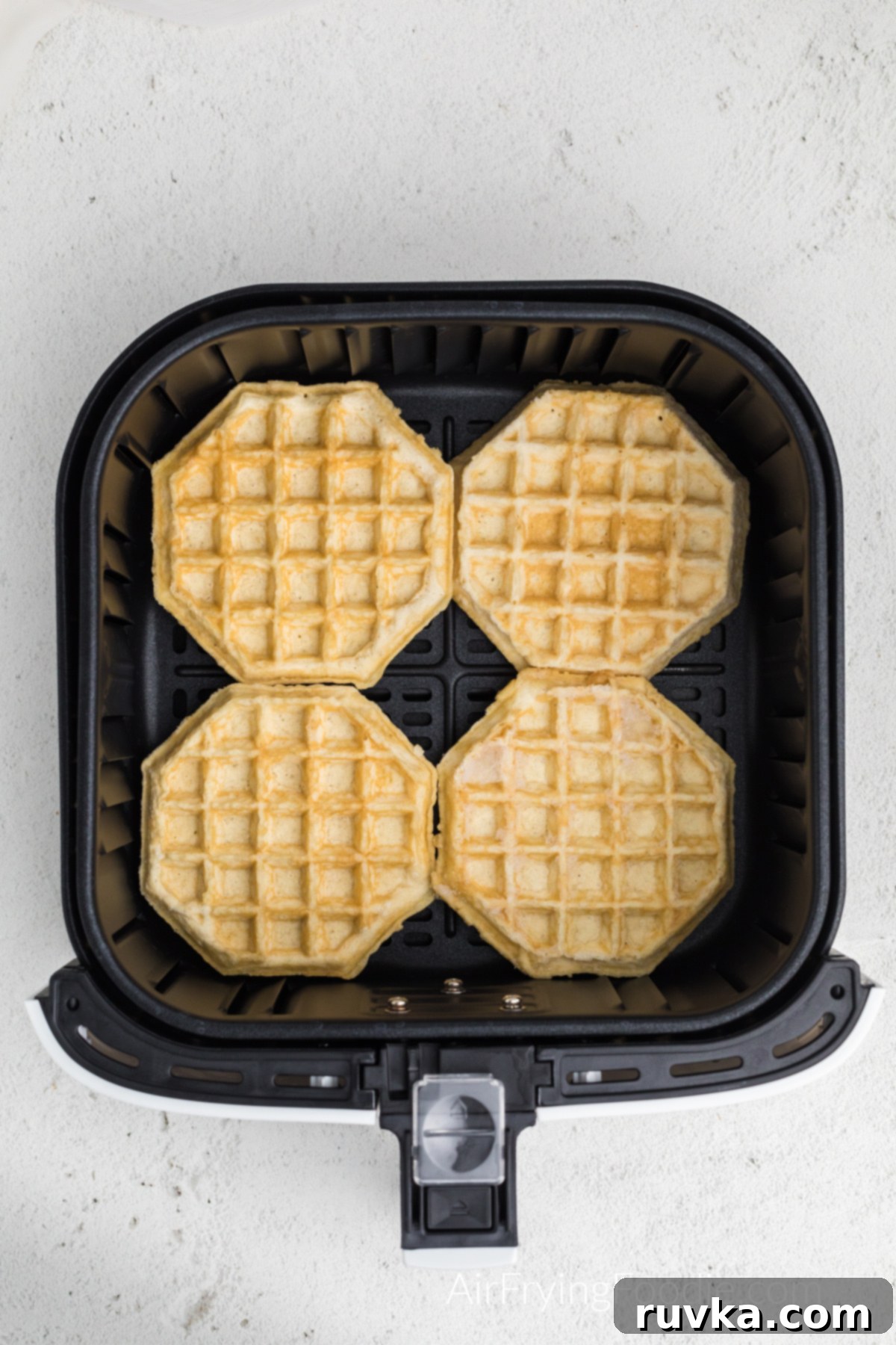 Frozen Waffles: Air Fryer Perfection 4 frozen waffles in air fryer basket, placed in a single layer.