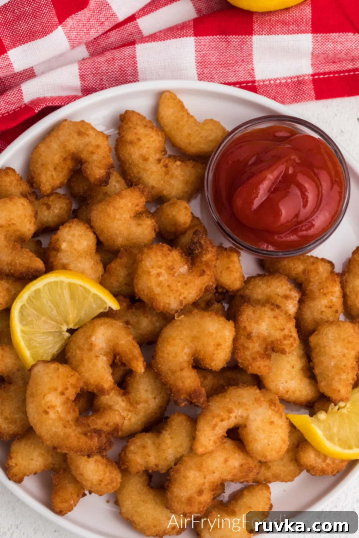Crispy Frozen Popcorn Shrimp in Air Fryer 7 Air fried frozen popcorn shrimp on a plate and ready to serve.