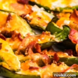Air Fryer Fiesta Mexican Delights 14 Bacon wrapped jalapenos in the air fryer basket with melted cheese.