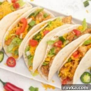 Air Fryer Fiesta Mexican Delights 3 Seasoned chicken in flour tortillas topped with shredded cheese and chopped tomatoes and peppers.