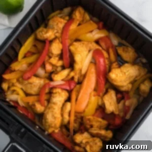 Air Fryer Fiesta Mexican Delights 5 chicken fajitas in air fryer basket ready to serve.