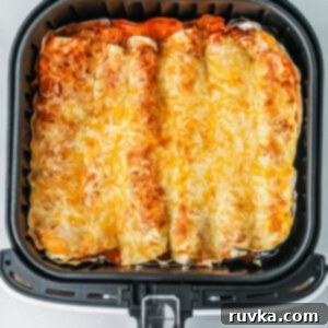 Air Fryer Fiesta Mexican Delights 6 Air fryer enchiladas in the basket, ready to serve.