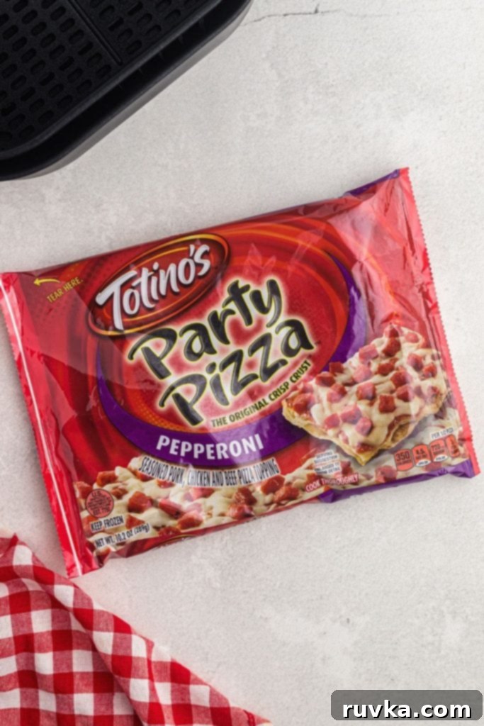 Crispy Air Fryer Tostino's Pizza 4 Packaged tostino's party pizza on a white counter with an air fryer basket