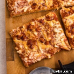 Crispy Air Fryer Tostino's Pizza 8 Cooked golden pizza ion a wooden cutting board with pizza cutter on table