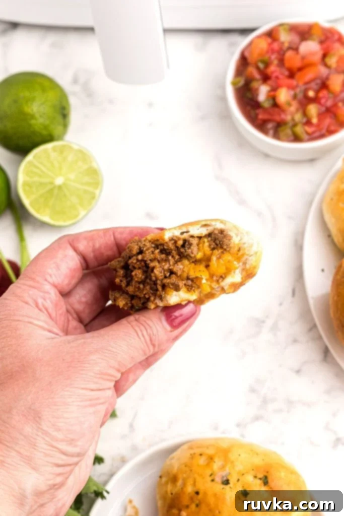 Crispy Air Fryer Taco Bombs 9 Juicy hamburger meat and melted cheddar cheese coming out of golden dough.