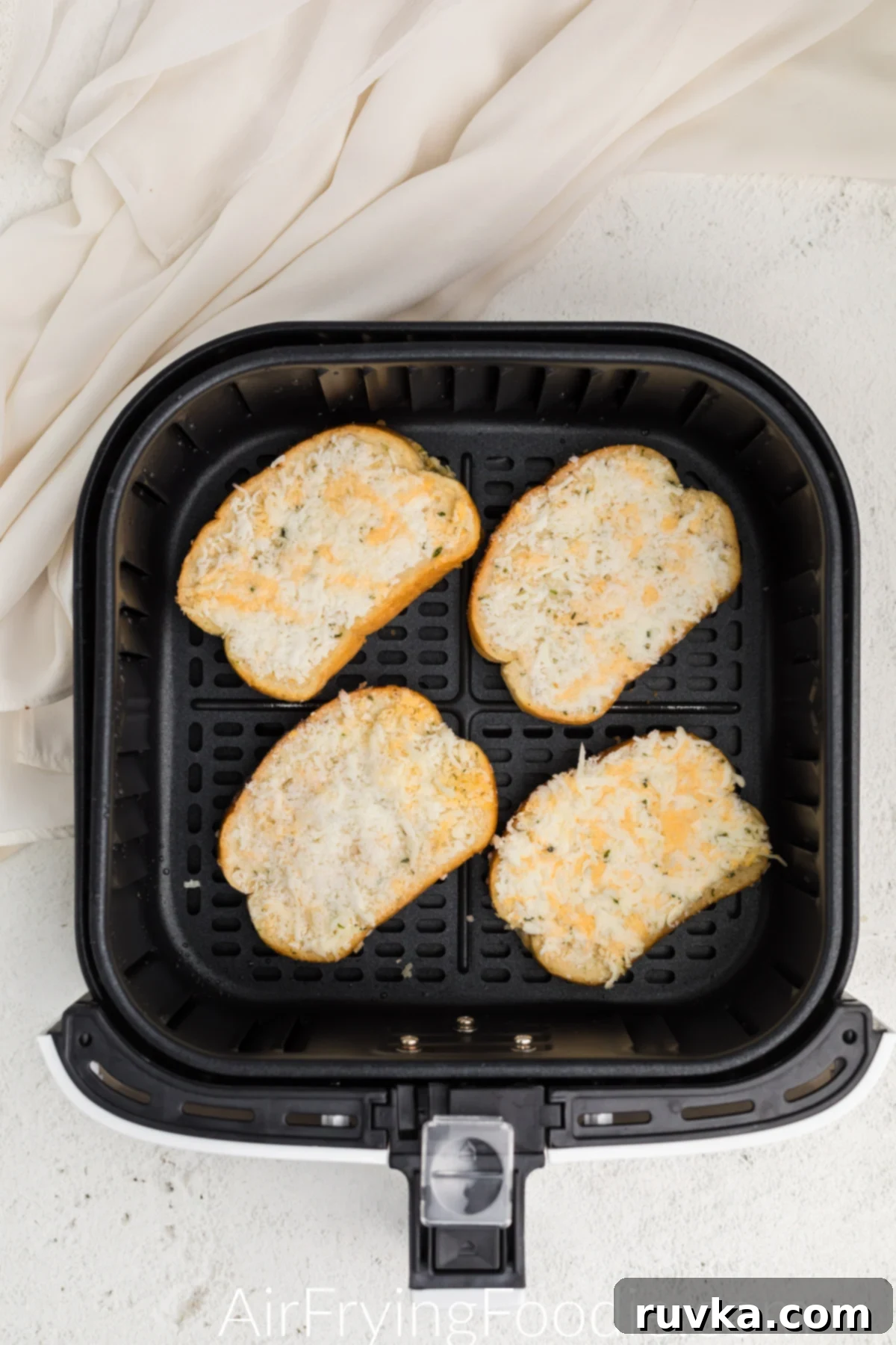 Crispy Air Fryer Texas Toast 4 Frozen Texas toast slices neatly arranged in a single layer inside an air fryer basket, ready for cooking.