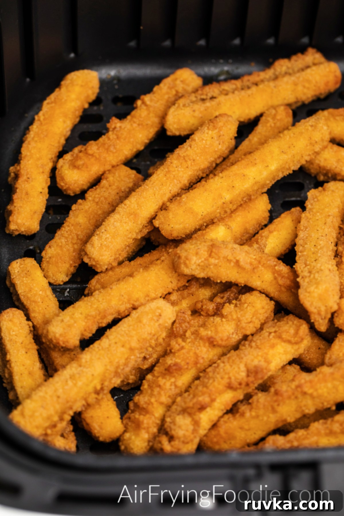 Crispy Air Fryer Frozen Chicken Fries 13 Fully cooked chicken fries in air fryer basket, perfectly golden and crispy.