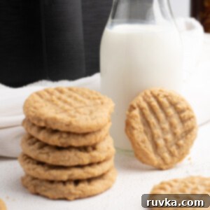 Chewy Air Fryer Peanut Butter Cookies 7 A stack of peanut butter cookies made in the Air Fryer with a glass of milk and the Air Fryer in the background.