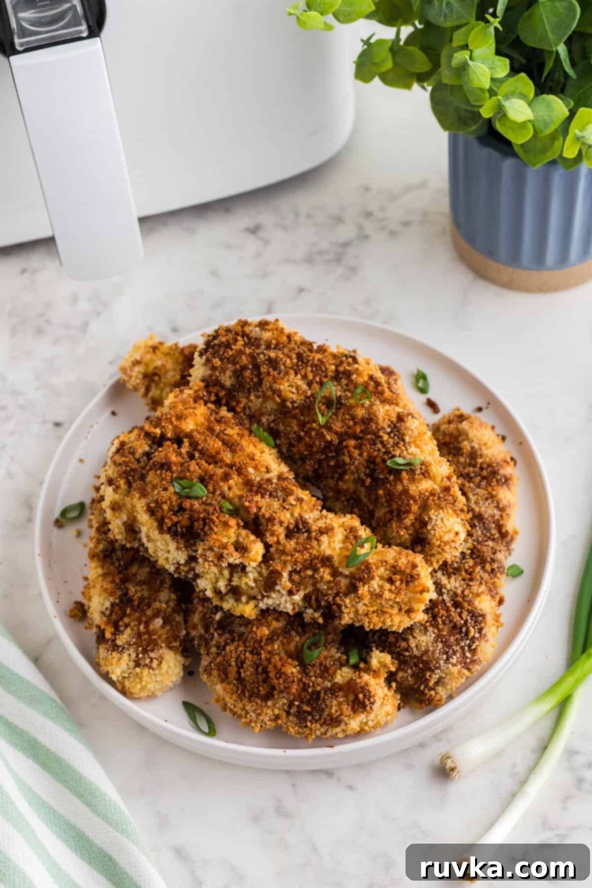 Crispy Air Fried Honey Garlic Chicken Strips 11 A close-up view of perfectly cooked Air Fryer Honey Garlic Chicken Tenders, highlighting their crispy coating and glistening sauce.
