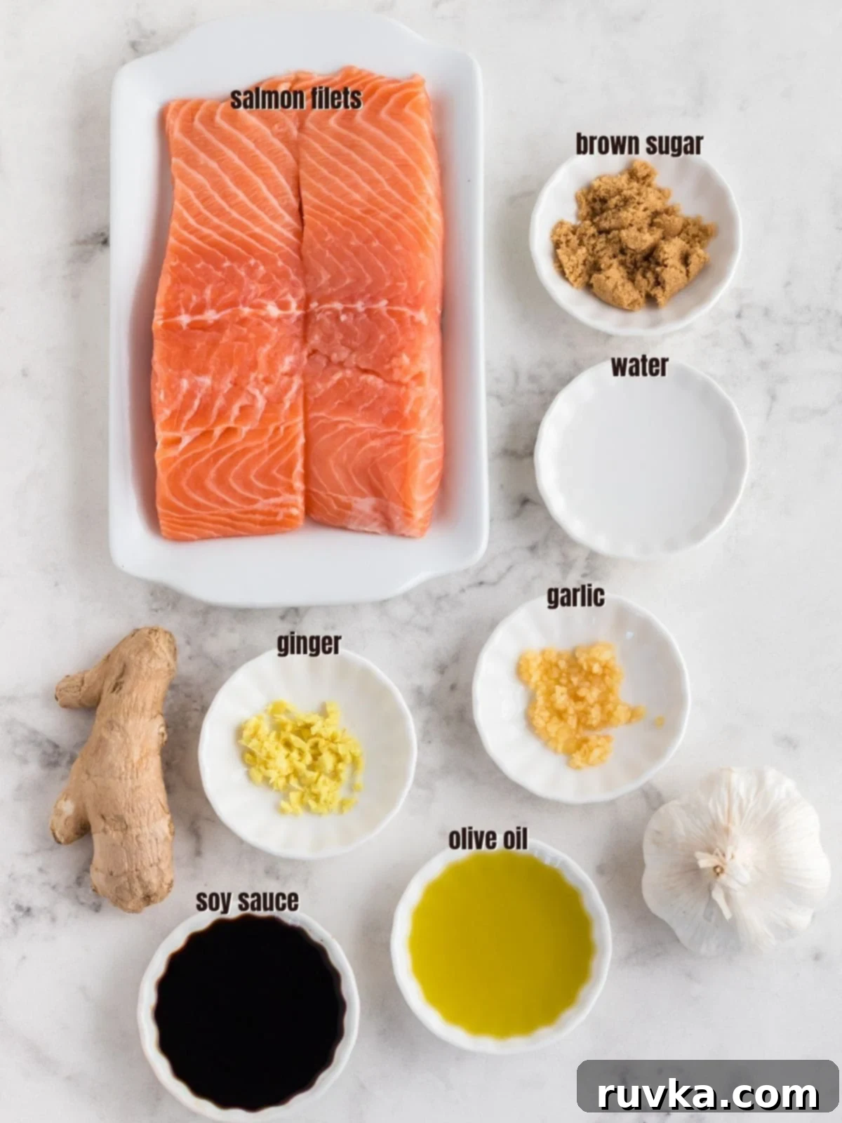 Collection of fresh ingredients for Air Fryer Teriyaki Salmon Bites: salmon fillets, soy sauce, fresh ginger, minced garlic, brown sugar, olive oil, and garnishes.